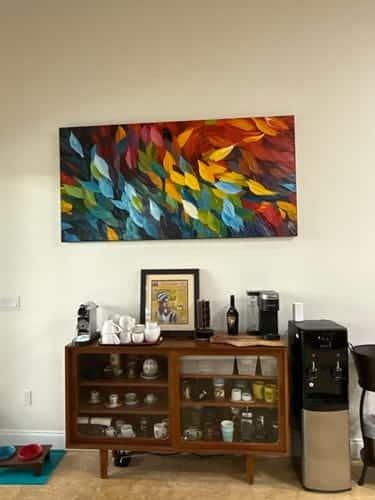 A large abstract painting in a corporate office setting