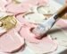 Close up of a palette knife creating 3D textured flower art with thick impasto paint.