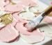 Close up of a palette knife creating 3D textured flower art with thick impasto paint.