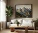 A modern living room featuring a large, textured abstract landscape painting of mountains.
