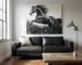 Large black and white textured horse painting hanging above a leather sofa in a modern rustic living room.