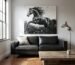 Large black and white textured horse painting hanging above a leather sofa in a modern rustic living room.