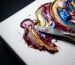 Close up of thick impasto paint creating abstract music wall art mimicking sound waves.
