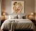 Heavily textured abstract lovers art painting hanging above a bed in a romantic master bedroom.